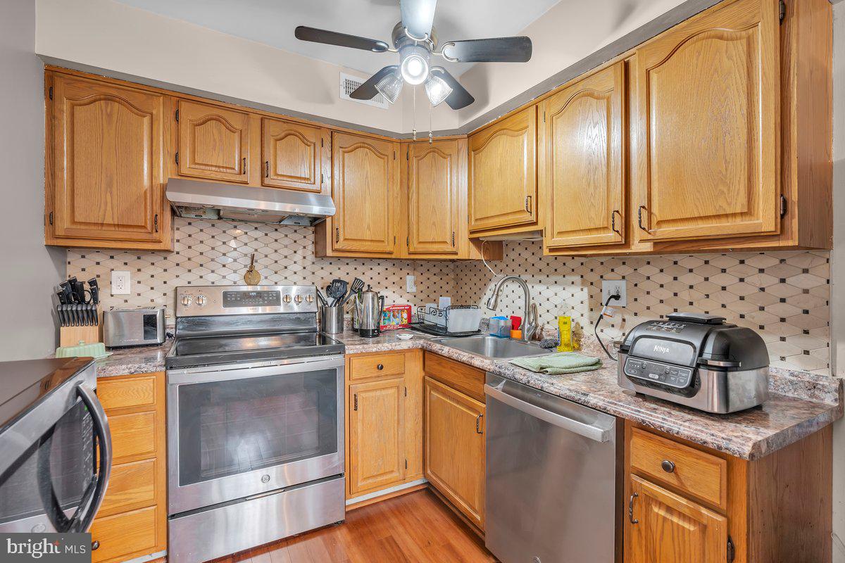 702 Winding Way Westville, NJ 08093 - Photo 6 of 22 a kitchen with stainless steel appliances granite countertop a sink stove and cabinets