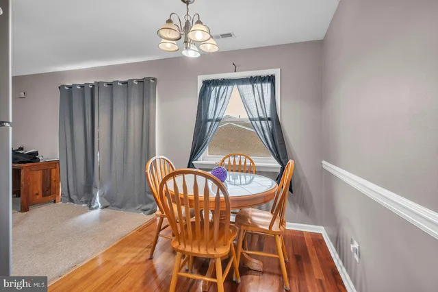 a view of a dining room with furniture and chandelier