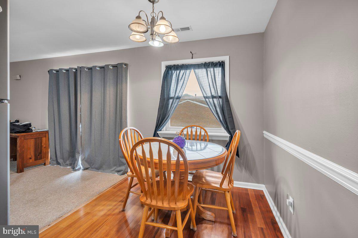 702 Winding Way Westville, NJ 08093 - Photo 9 of 22 a view of a dining room with furniture and chandelier