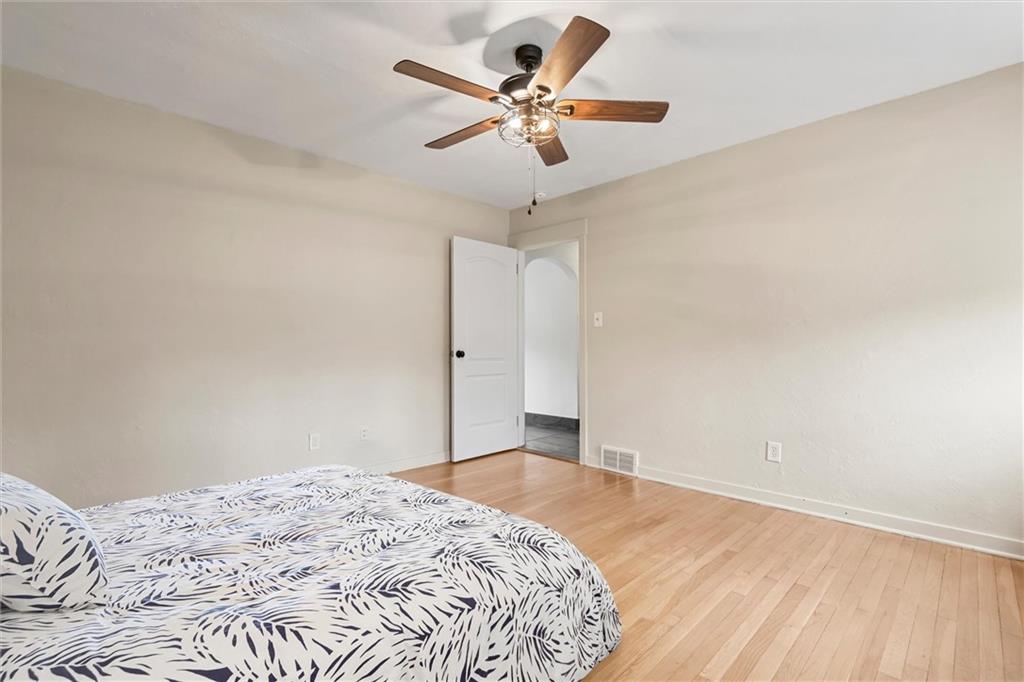 1110 10th Street Irwin, PA 15642 - Photo 13 of 50 a bedroom with a bed and a chandelier fan