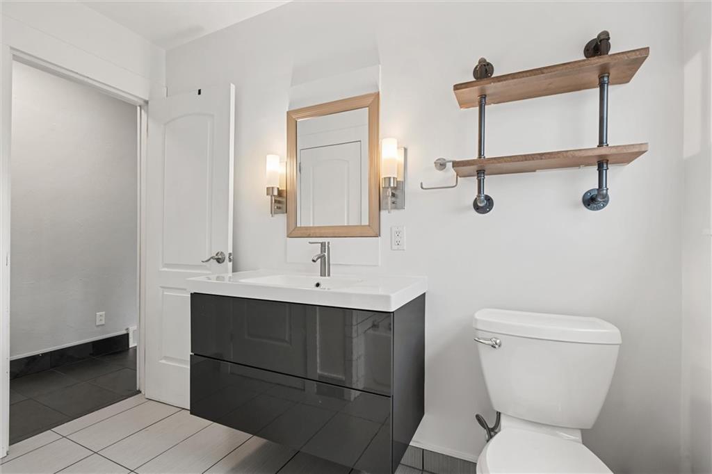 1110 10th Street Irwin, PA 15642 - Photo 20 of 50 a bathroom with a toilet sink and mirror