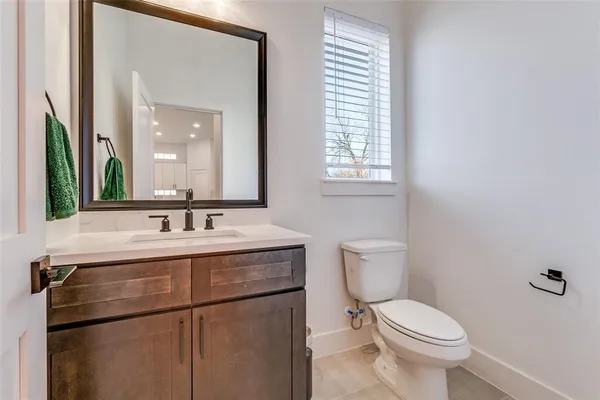 a bathroom with a toilet a sink and a mirror