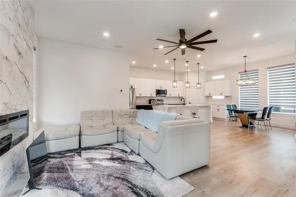 a living room with furniture and kitchen view
