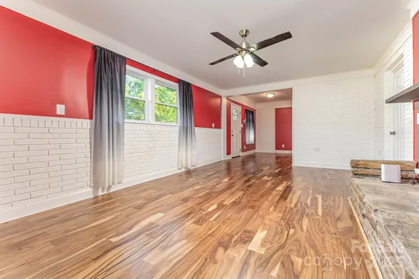 a view of a dining room with hardwood floor and a large window