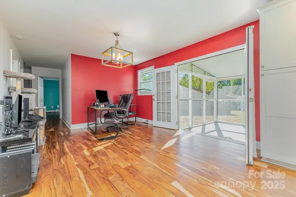 a kitchen with stainless steel appliances granite countertop a stove and cabinets with wooden floor