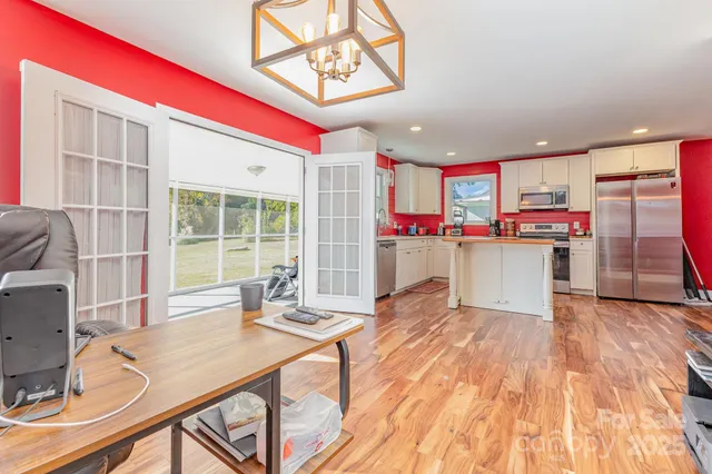 a kitchen with stainless steel appliances granite countertop a stove and white cabinets