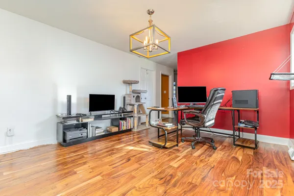 a view of living room kitchen with stainless steel appliances granite countertop furniture and living room view