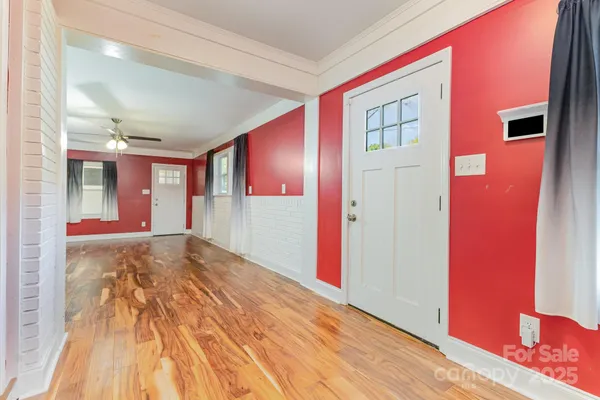 a view of a room with wooden floor
