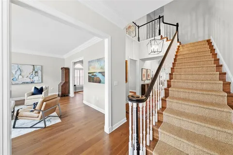 a view of entryway and hall with wooden floor