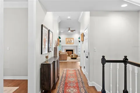 a view of a hallway with furniture and wooden floor