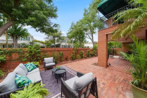 a view of a balcony with chairs and a potted plant