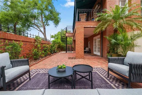 a view of a porch with furniture and garden