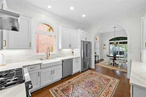 a kitchen with stainless steel appliances granite countertop a stove and a refrigerator