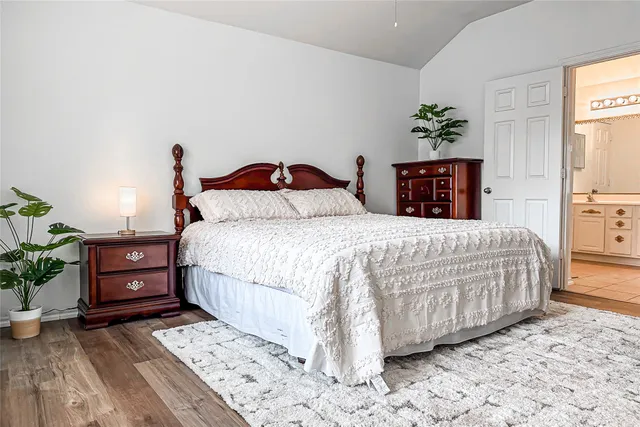 a bedroom with a bed and a potted plant