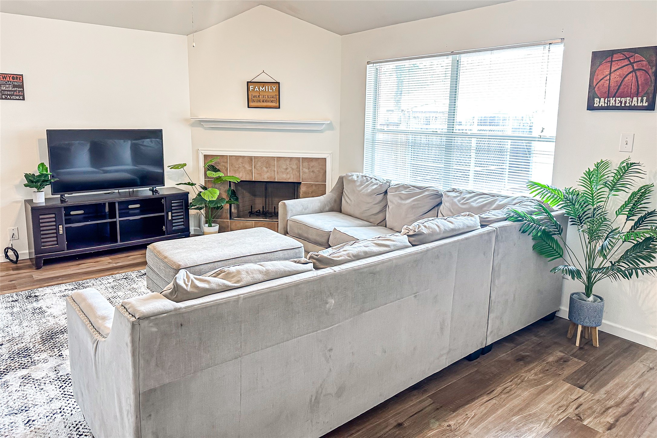 12426 Gershwin Oak Street Houston, TX 77089 - Photo 11 of 12 a living room with furniture a flat screen tv and a fireplace