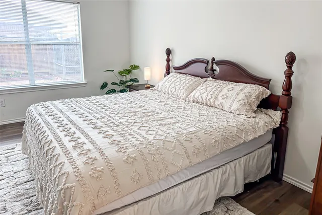a bed sitting in a bedroom next to a window
