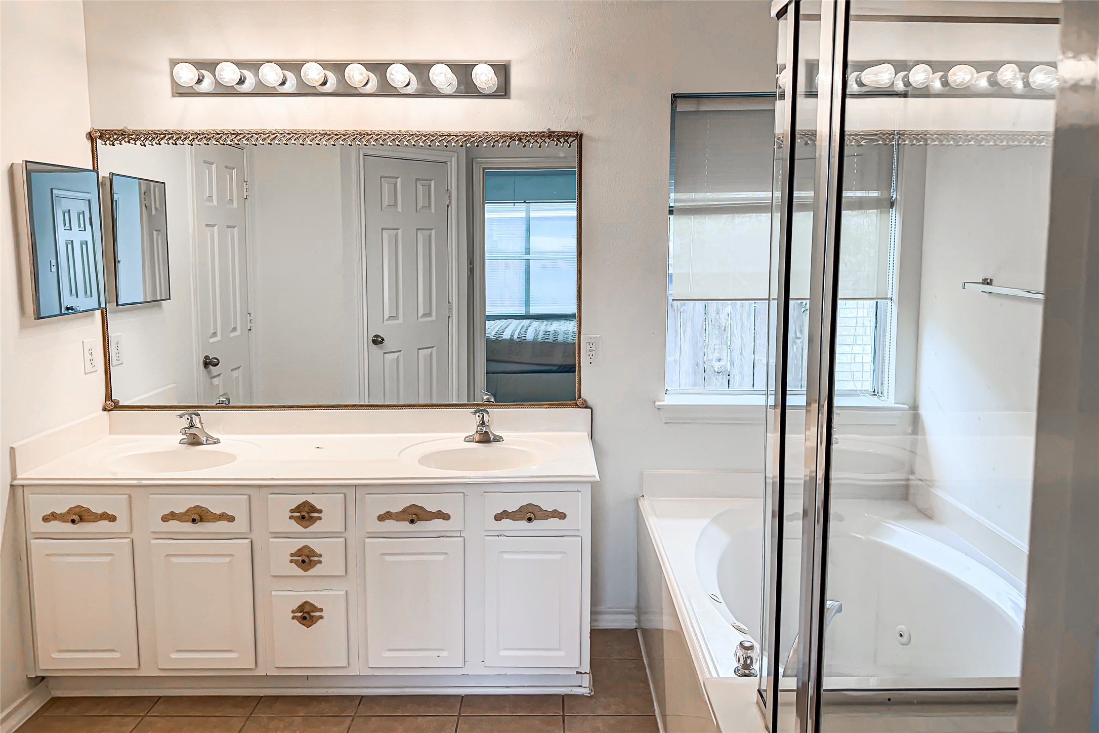 12426 Gershwin Oak Street Houston, TX 77089 - Photo 4 of 12 a bathroom with a sink vanity and mirror