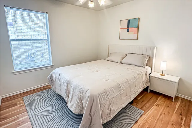 a spacious bedroom with a bed and a window