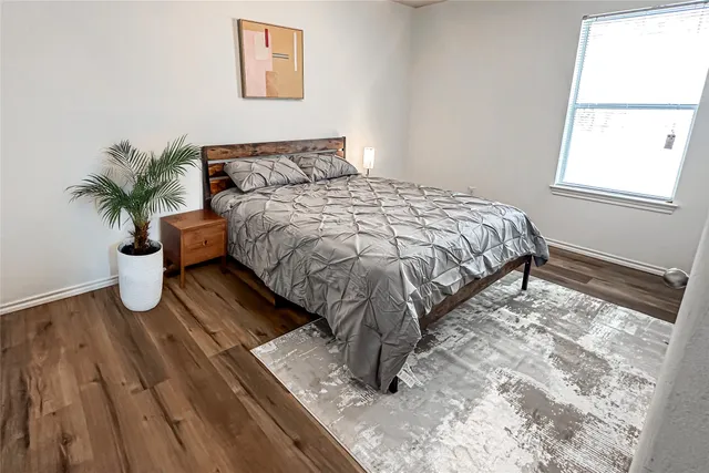 a bed sitting in a bedroom next to a window