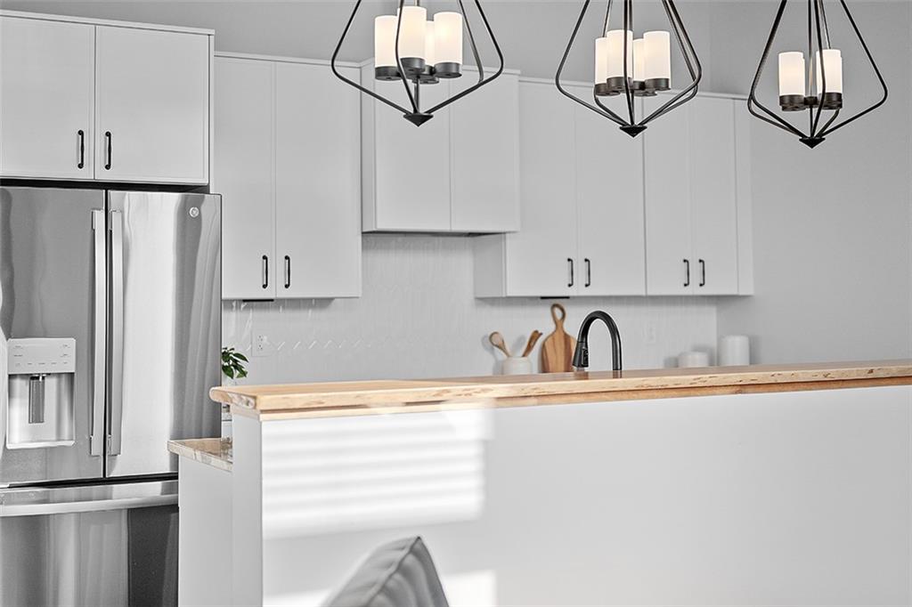 3080 Smallman Street Pittsburgh, PA 15201 - Photo 19 of 48 a kitchen with stainless steel appliances granite countertop a sink a stove and a refrigerator with wooden floor