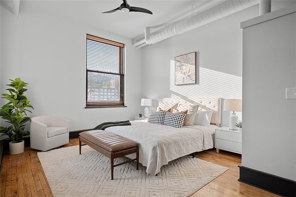 3080 Smallman Street Pittsburgh, PA 15201 - Photo 23 of 48 a bedroom with a bed couch and a potted plant