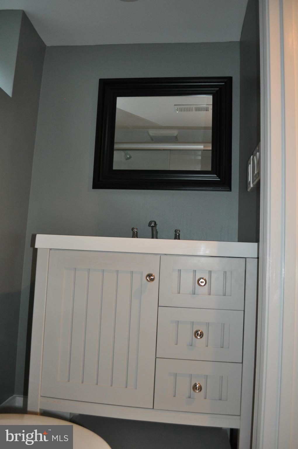 8738 Ridge Road Bethesda, MD 20817 - Photo 19 of 30 a bathroom with a sink and a mirror