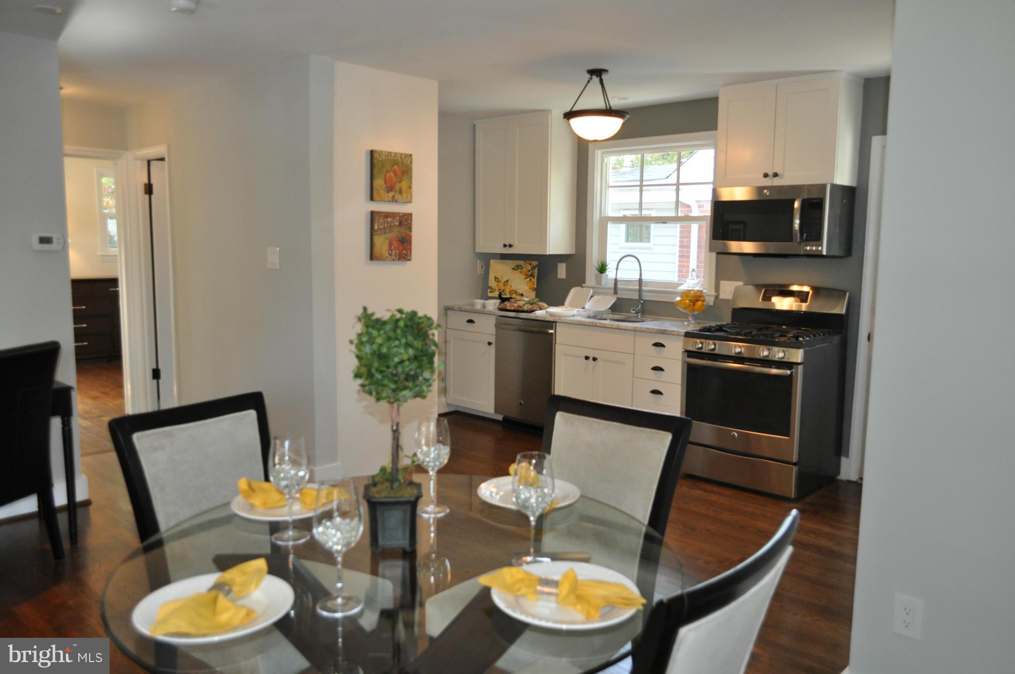 8738 Ridge Road Bethesda, MD 20817 - Photo 6 of 30 a kitchen with a table chairs and a stove