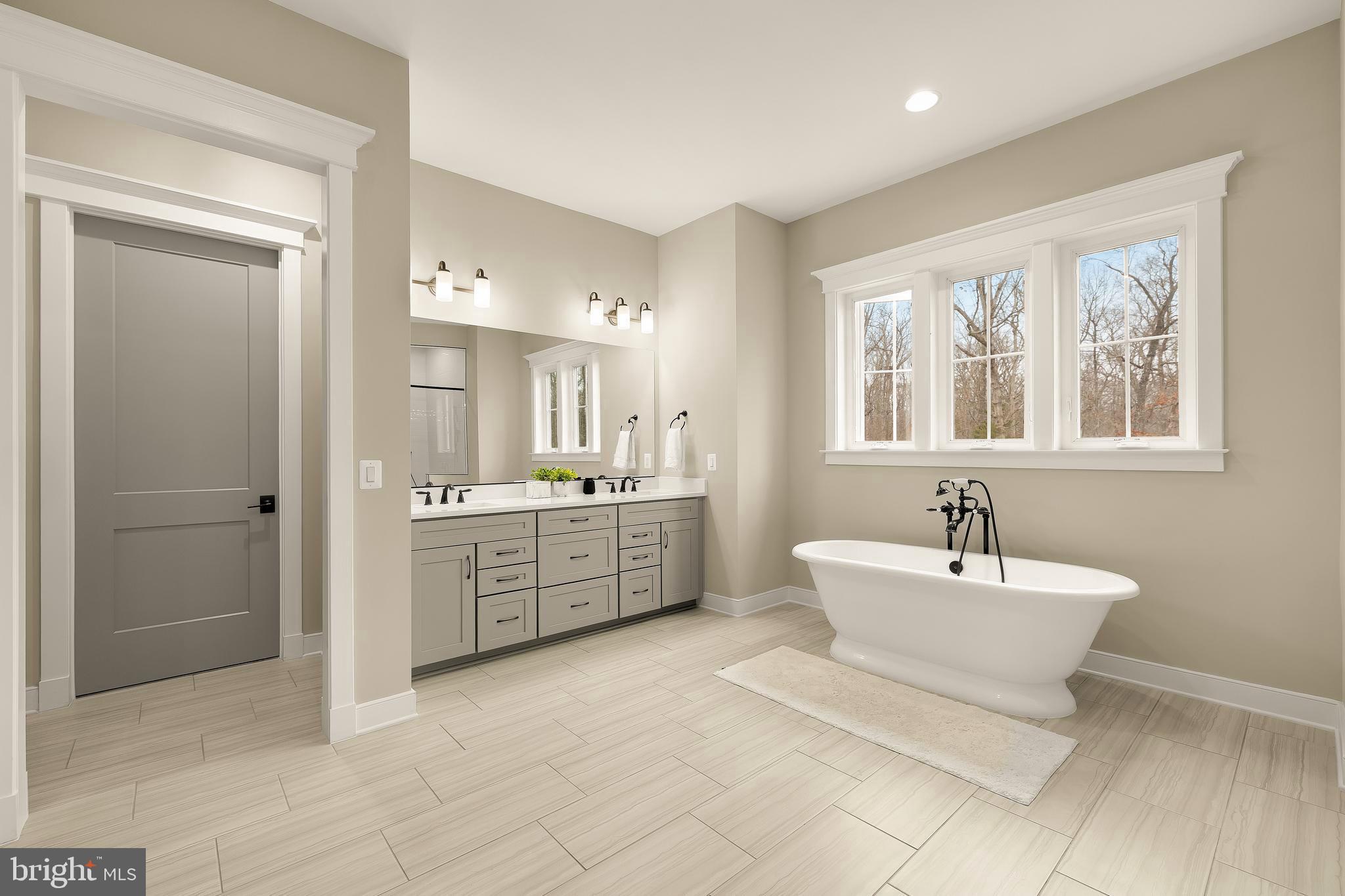 12650 Popes Head Road Clifton, VA 20124 - Photo 31 of 69 a spacious bathroom with a double vanity sink mirror and bathtub