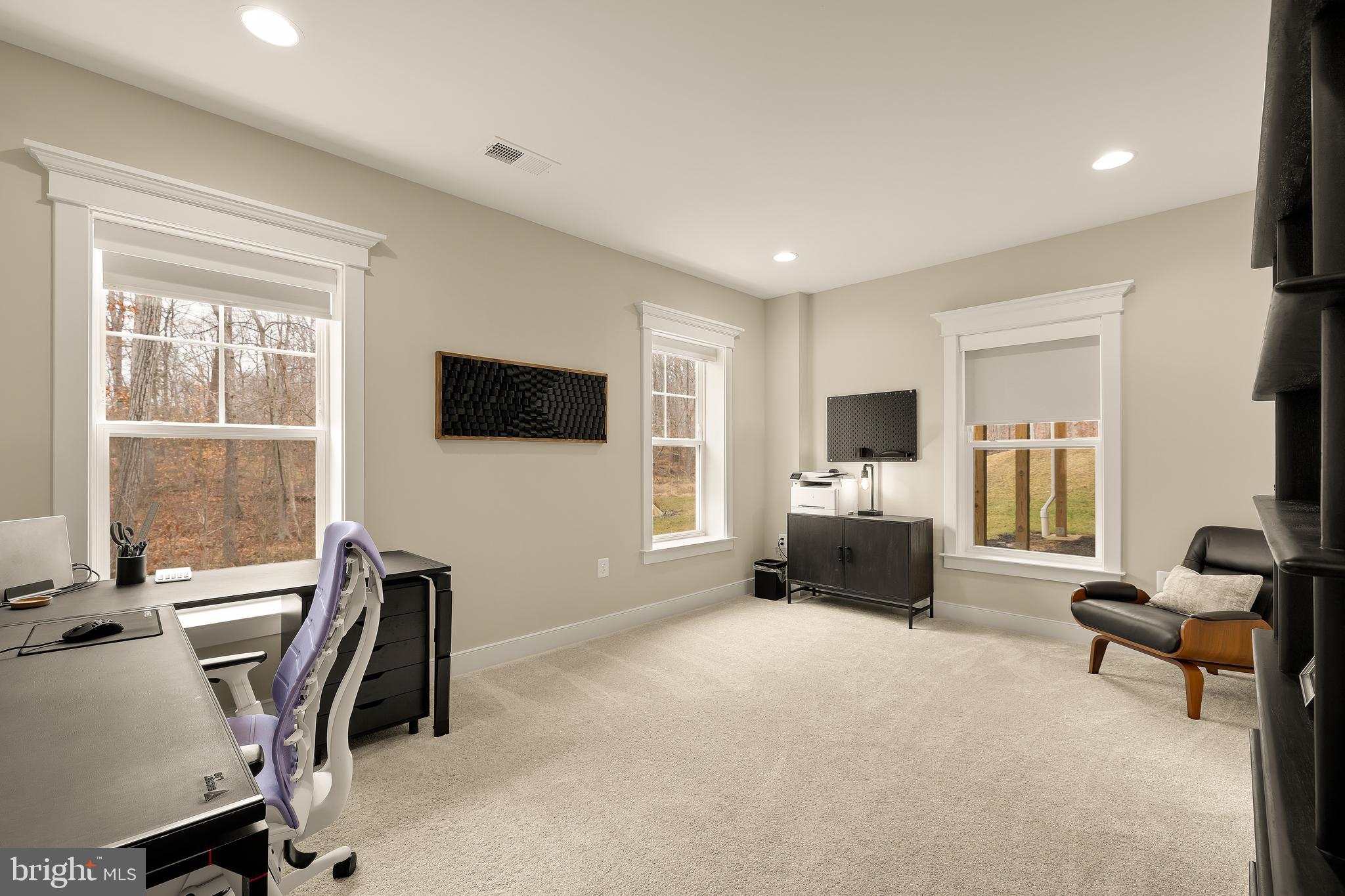 12650 Popes Head Road Clifton, VA 20124 - Photo 56 of 69 a living room with furniture a flat screen tv and a window