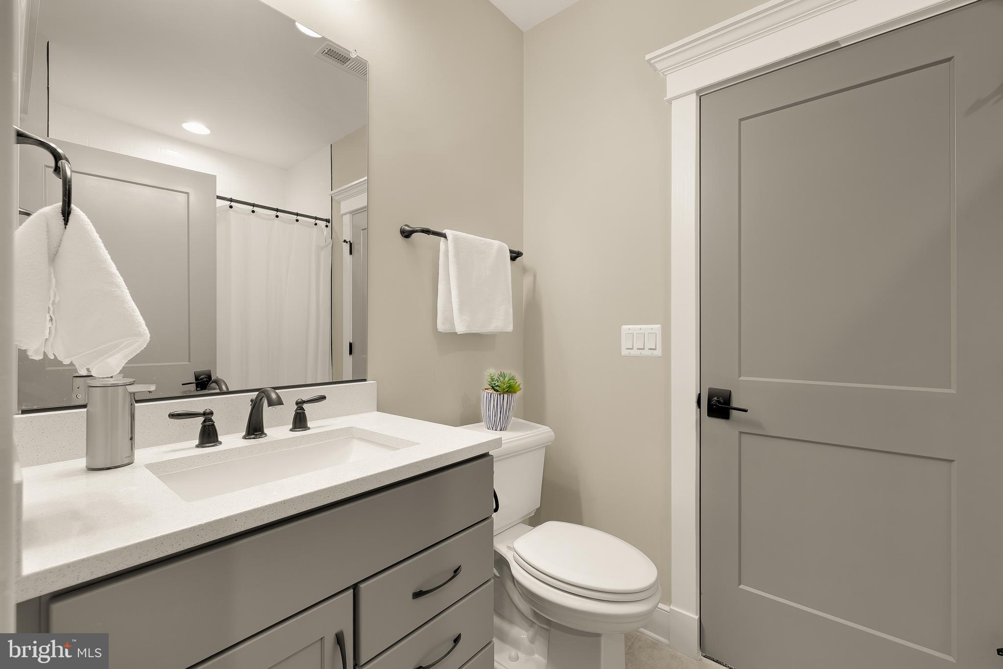 12650 Popes Head Road Clifton, VA 20124 - Photo 57 of 69 a bathroom with a granite countertop sink toilet and shower