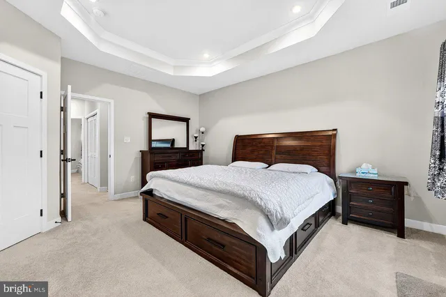 a bedroom with a bed and a mirror