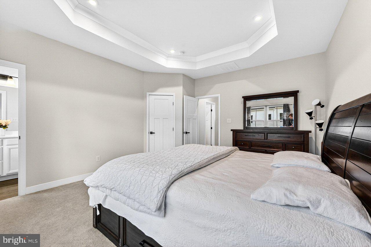 39 Sage Way Mount Laurel, NJ 08054 - Photo 15 of 32 a bedroom with a large bed and wooden floor