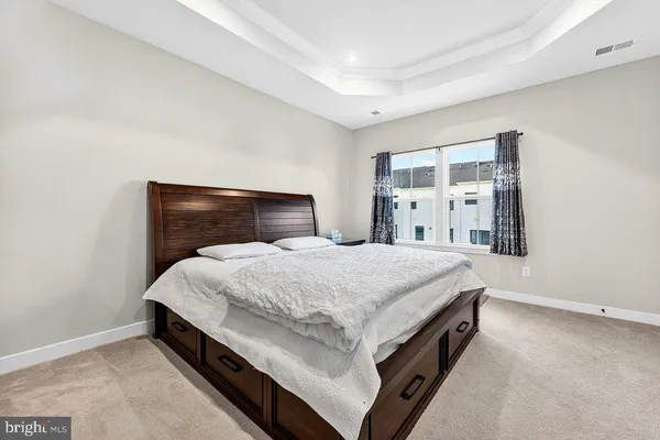 a spacious bedroom with a bed and window