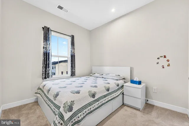 a bedroom with a bed and a mirror