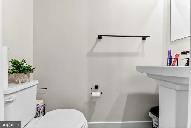 a white toilet sitting next to a bathroom sink