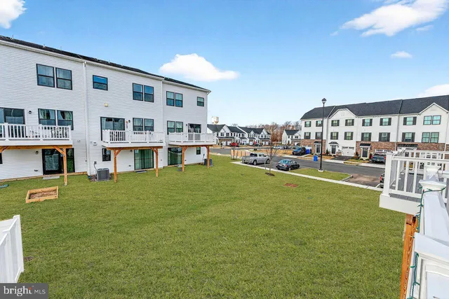 a front view of a house with a yard table and chairs