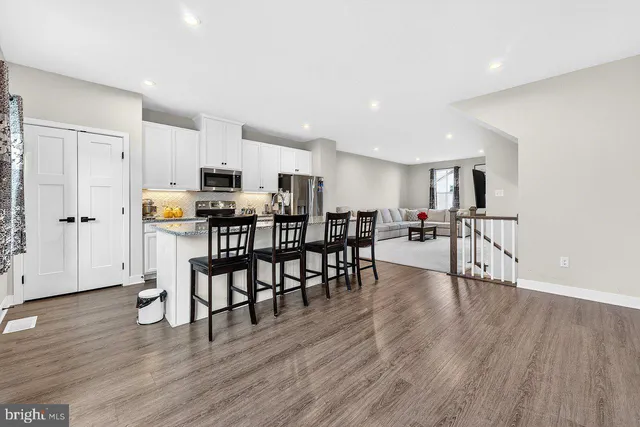 a view of kitchen with cabinets and wooden floor