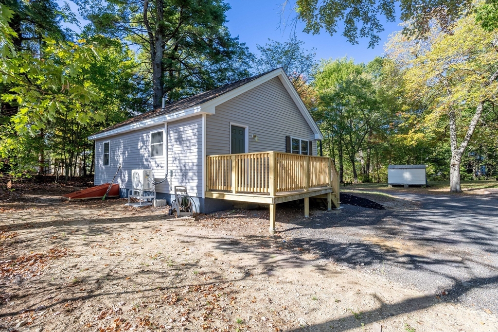 7 Groveland Street Ayer, MA 01432 - Photo 2 of 35 a view of a house with a yard and trees in the background