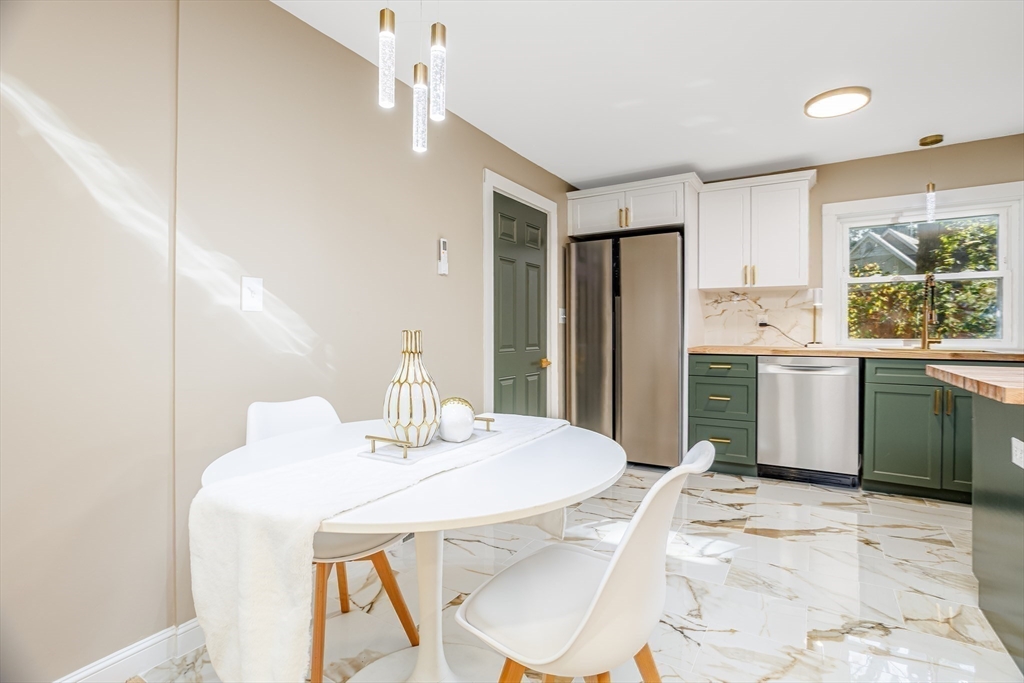 7 Groveland Street Ayer, MA 01432 - Photo 22 of 35 a kitchen with a sink a refrigerator and a stove