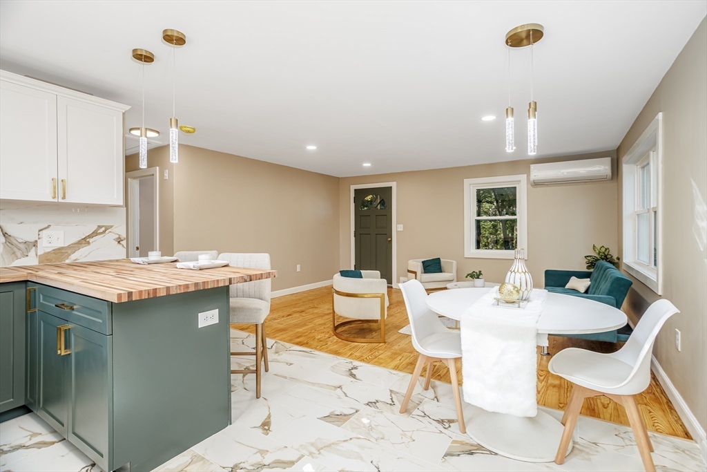 7 Groveland Street Ayer, MA 01432 - Photo 25 of 35 a view of a kitchen with a dining table and chairs