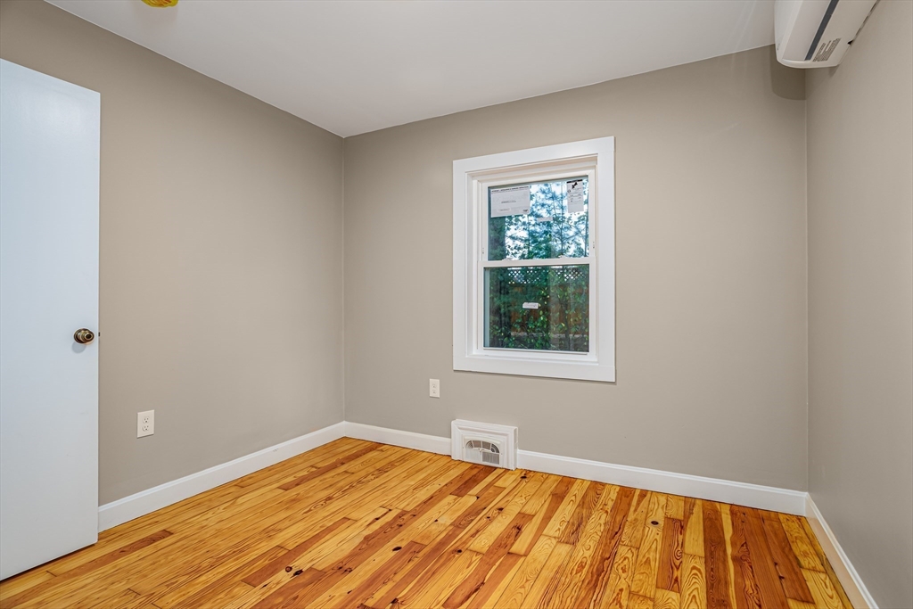 7 Groveland Street Ayer, MA 01432 - Photo 33 of 35 a view of an empty room with wooden floor and a window