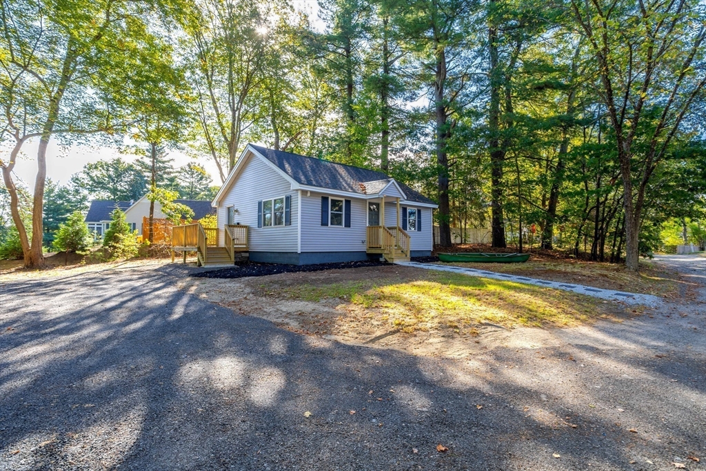 7 Groveland Street Ayer, MA 01432 - Photo 5 of 35 a view of house that has a large tree with wooden fence