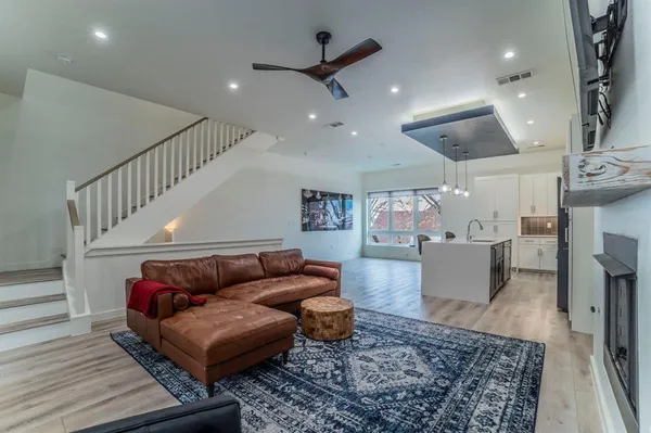 a living room with furniture and wooden floor