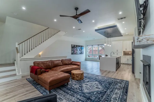 a living room with furniture and wooden floor