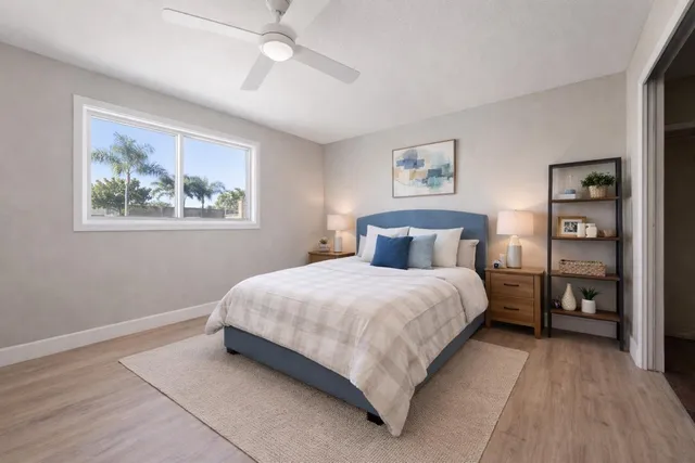 a bedroom with a bed and a painting on the wall