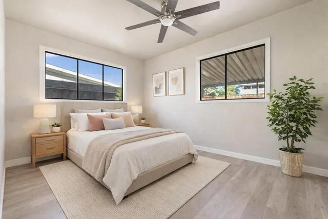 a bedroom with a large bed and a chandelier