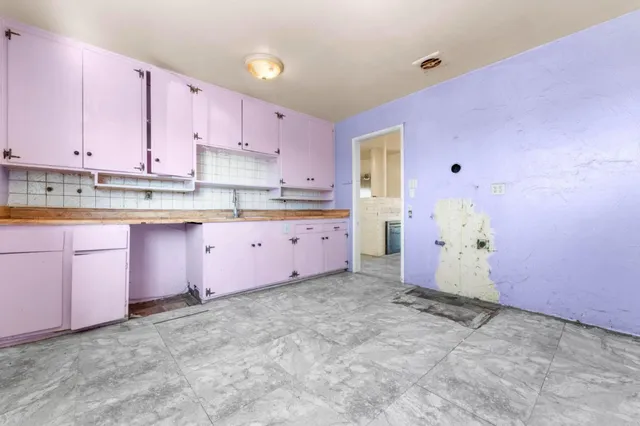 a kitchen with granite countertop a sink and cabinets
