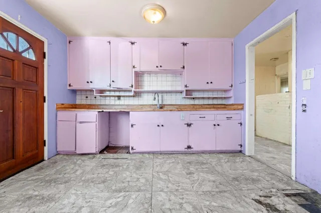 a view of kitchen with granite countertop cabinets and stainless steel appliances