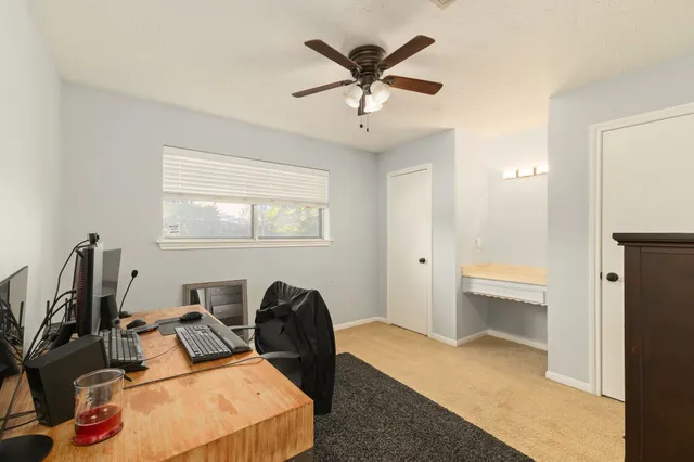 a living room with furniture a window and a flat screen tv