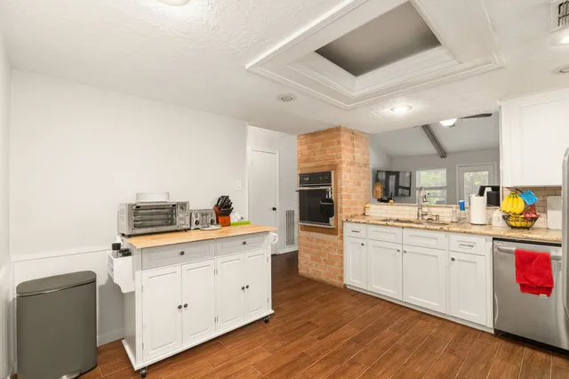 a kitchen with cabinets a sink and appliances